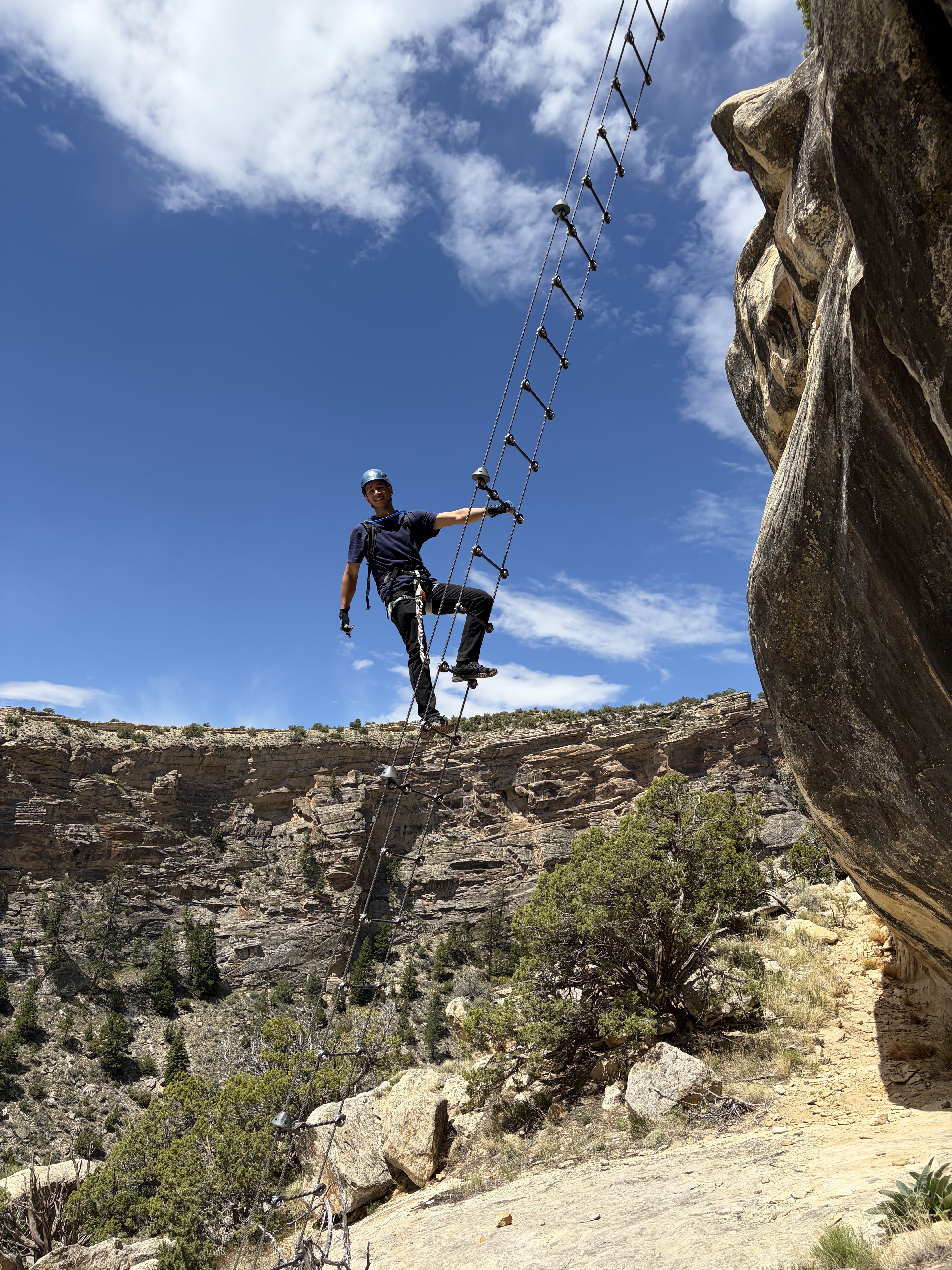 Shaun on the rope ladder at Ashley Gorge Via Ferrata
